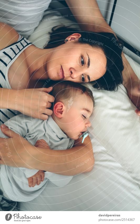 Couple with son lying over bed Beautiful Illness Bedroom Child Human being Baby Toddler Woman Adults Man Parents Mother Father Family & Relations Observe Love
