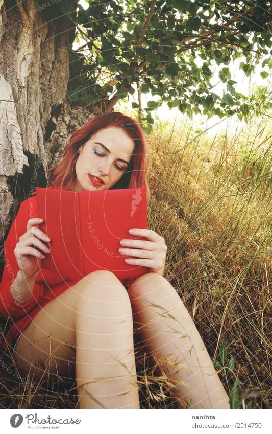 Young redhead woman reading a red book Lifestyle Beautiful Wellness Harmonious Well-being Senses Relaxation Leisure and hobbies Education Study Student