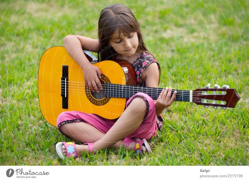 Girl with a guitar Music Child School Human being Boy (child) Guitar Musical notes Flower Grass Green Pink girl student spanish handsome people instrument