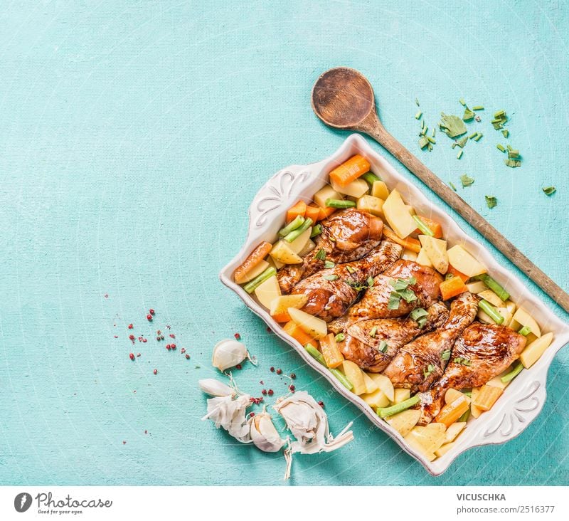 Chicken legs with vegetables in baking pot Food Meat Vegetable Nutrition Lunch Dinner Organic produce Crockery Style Design Table Kitchen Wooden spoon Cooking