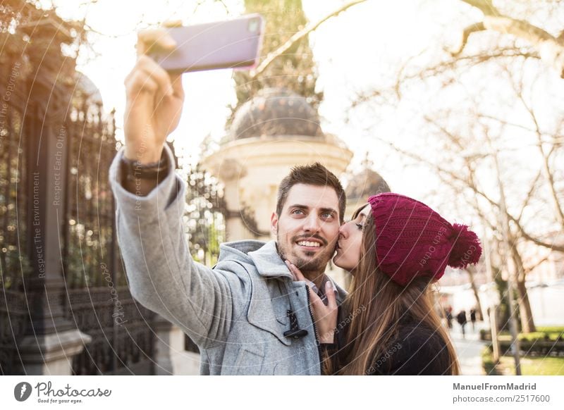 couple taking selfie in the street Lifestyle Elegant Style Joy Happy Beautiful Vacation & Travel Tourism Sightseeing Winter Telephone PDA Camera Human being