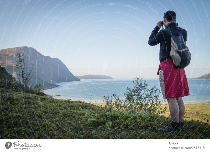 Young man looks through a ferrule at a fjord Relaxation Vacation & Travel Trip Adventure Far-off places Freedom Hiking Youth (Young adults) Landscape Fjord