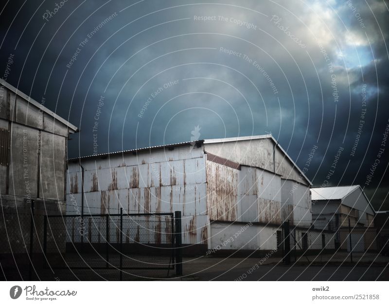 deposit Sky Clouds Corrugated iron wall Warehouse Metal Old Threat Dark Colour photo Subdued colour Exterior shot Deserted Copy Space left Copy Space right