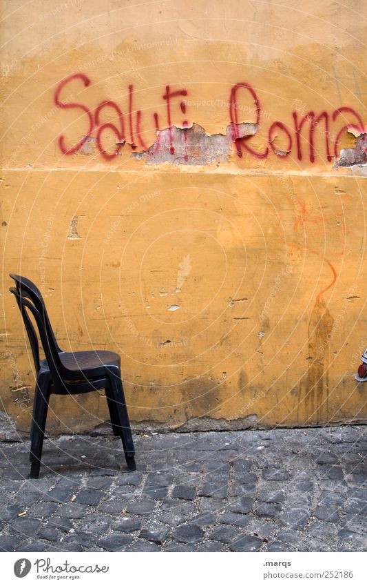 Saluti Roma Lifestyle City trip Chair Rome Italy Capital city Wall (barrier) Wall (building) Characters Old Dirty Orange Graffiti Salutation Colour photo