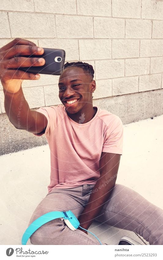 Young happy man taking a selfie Lifestyle Style Design Joy Leisure and hobbies Cellphone Headset Camera PDA Technology Entertainment electronics Human being