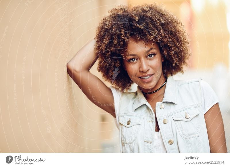 Young black woman, afro hairstyle, smiling outdoors - a Royalty Free Stock  Photo from Photocase