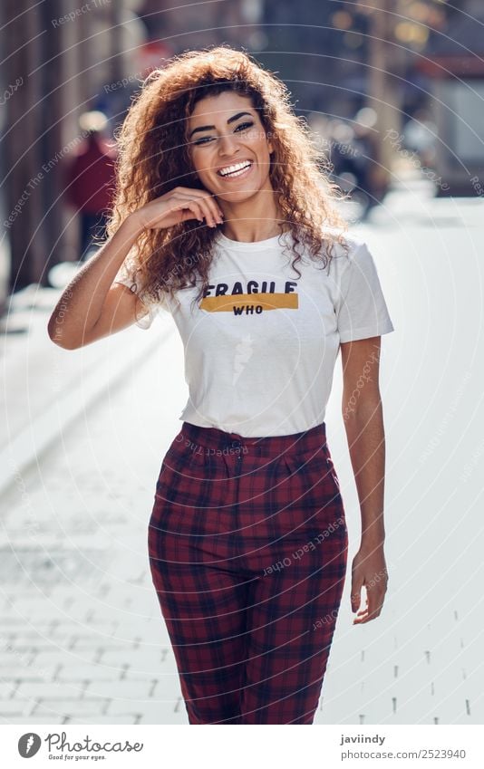 Smiling young Arab woman with black curly hairstyle Lifestyle Style Joy Beautiful Hair and hairstyles Human being Feminine Young woman Youth (Young adults)
