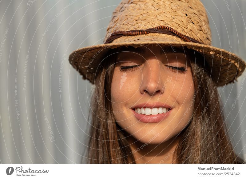 portrait of a young woman with eyes closed Lifestyle Elegant Joy Happy Beautiful Face Summer Sunbathing Human being Woman Adults Fashion Hat Brunette Smiling