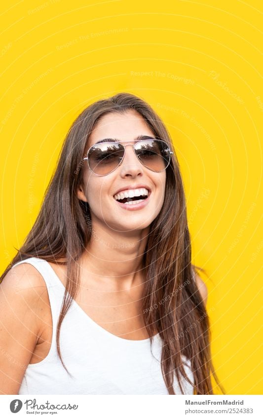 attractive young woman with sunglasses against yellow background Style Joy Happy Beautiful Summer Human being Woman Adults Fashion Sunglasses Smiling Stand