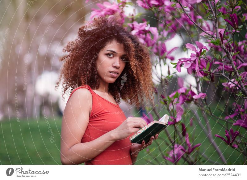 smart afro woman holding a book Lifestyle Happy Beautiful Leisure and hobbies Reading Summer Garden School Study Camera Human being Woman Adults Book Nature