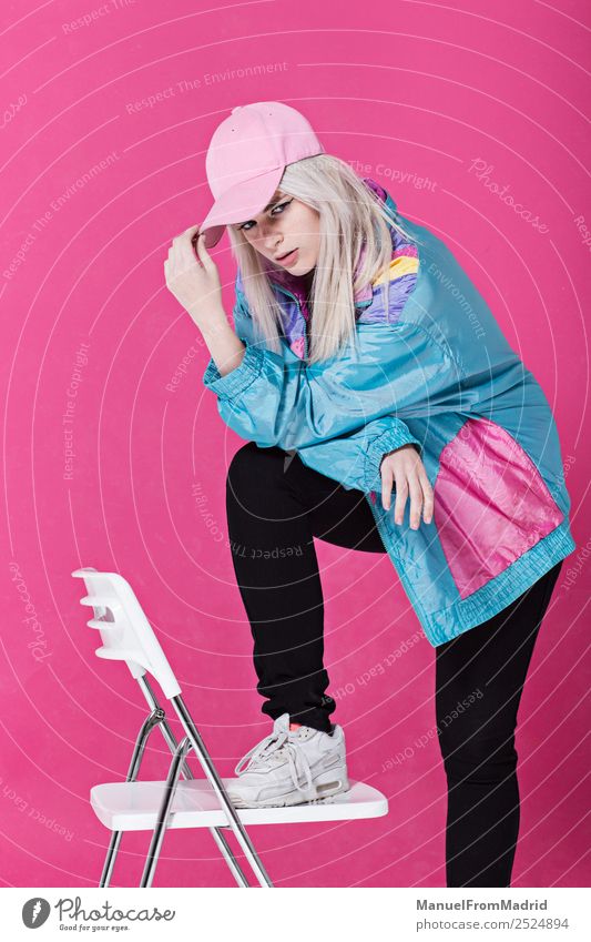 Stylish young woman posing Lifestyle Style Beautiful Make-up Chair Woman Adults Fashion Clothing Retro Crazy Cool (slang) 80s pink background swag Lean teenager