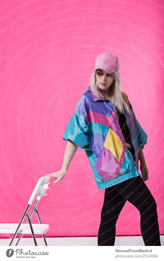 Stylish young woman posing Lifestyle Style Beautiful Make-up Chair Woman Adults Fashion Clothing Retro Crazy Cool (slang) 80s pink background swag Lean teenager