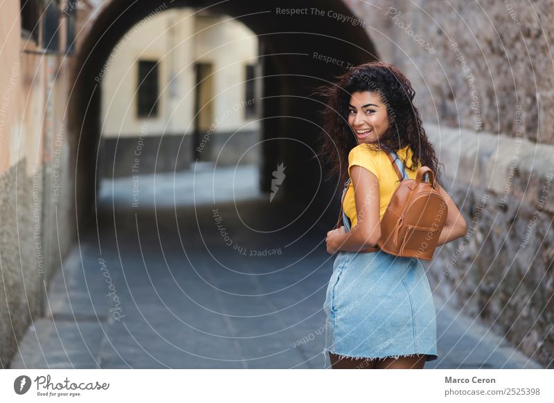 beautiful mixed girl casual dressed with backpak  walking happy in the street african backpack black blue brown hair curly hair day enjoying lifestyle long hair