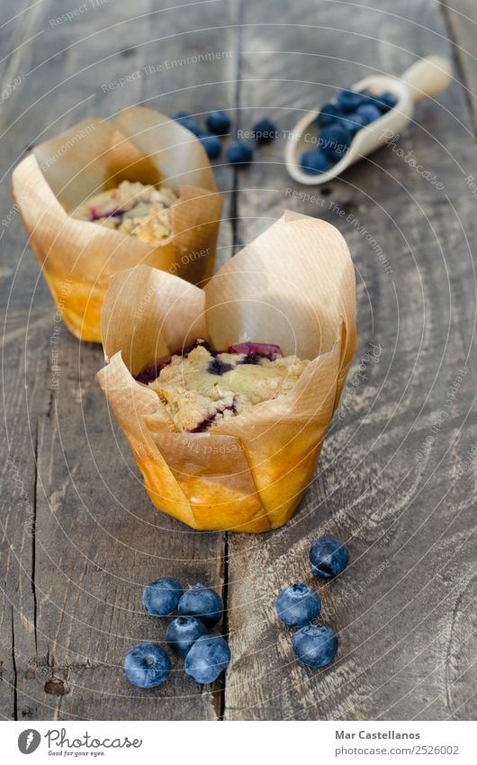 Muffins with blueberries on wooden background Dough Baked goods Cake Dessert Breakfast Organic produce Diet Table Paper Feeding Dark Fresh Small Delicious Brown