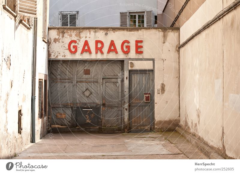 garage Downtown House (Residential Structure) Building Wall (barrier) Wall (building) Facade Characters Old Authentic Town Brown Gray Red Garage Garage door
