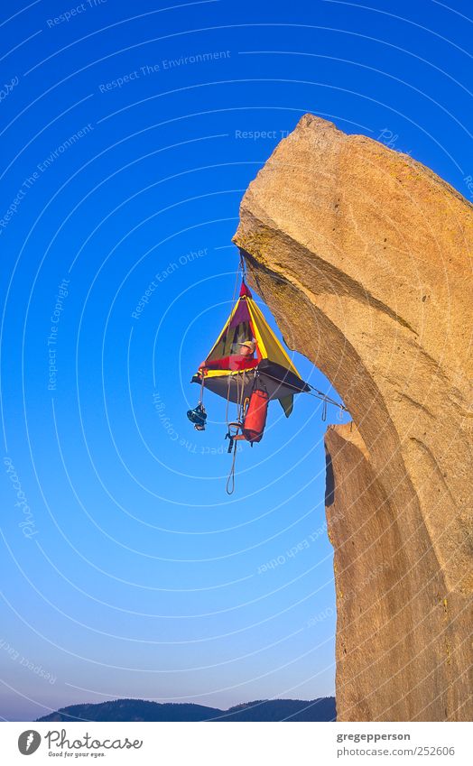 Climber and his camp dangling from a cliff. Life Camping Sports Man Adults 1 Human being Hang Self-confident Success Willpower Brave Trust achievement Balance
