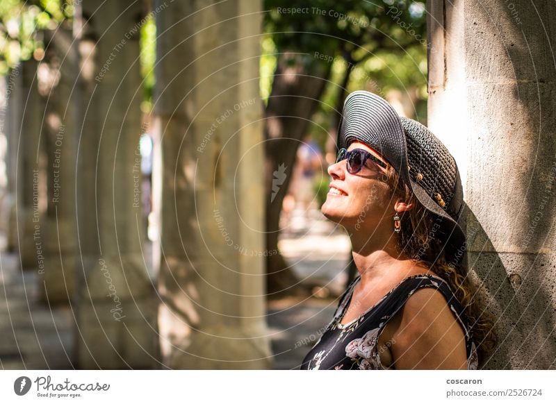 Woman leaning against a column with sunbeams on her face Lifestyle Style Happy Beautiful Skin Face Vacation & Travel Summer Sun Human being Feminine Adults 1