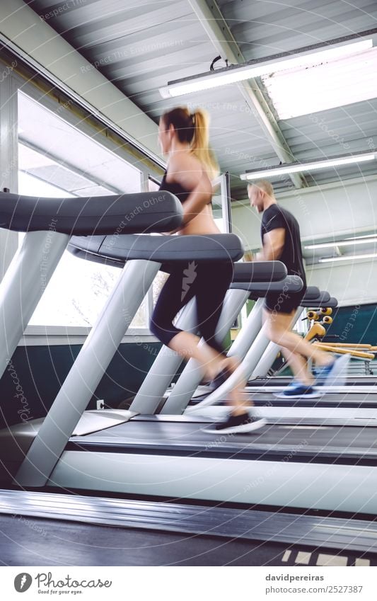 People in motion during a treadmill training Lifestyle Leisure and hobbies Sports Jogging Human being Woman Adults Man Friendship Sneakers Movement Fitness