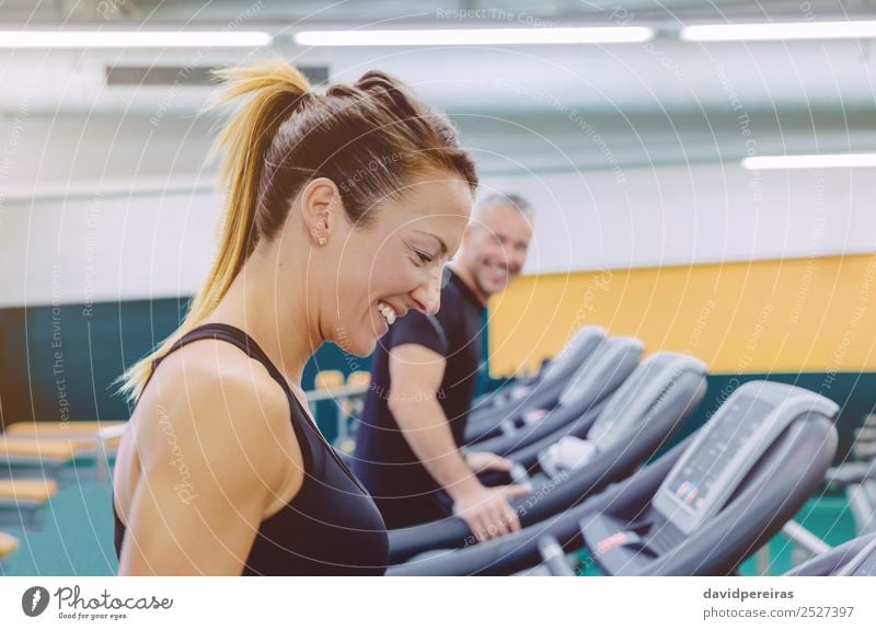Fitness woman with friend in treadmill training Lifestyle Joy Happy Beautiful Face Leisure and hobbies Sports Jogging Human being Woman Adults Man Friendship
