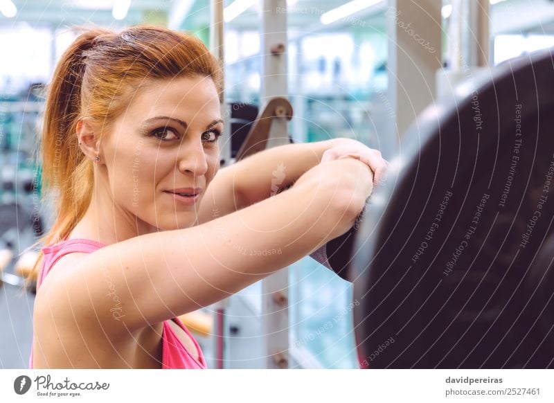 Woman smiling and resting over barbell after training Lifestyle Joy Happy Beautiful Body Sports Camera Human being Adults Arm Fitness Smiling Authentic Thin