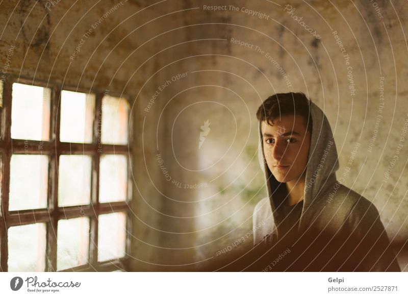 Hooded teenage boy in an abandoned house illuminated by a windo Lifestyle Face Child Human being Boy (child) Man Adults Youth (Young adults) Street Fashion