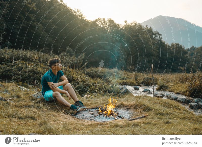 Campfire Melancholy Lifestyle Camping Masculine Young man Youth (Young adults) 1 Human being 13 - 18 years Nature Warmth Meadow Brook River Think Sit Simple