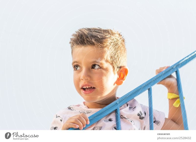 Little boy leaning on a railing in a white and blue village Lifestyle Joy Happy Beautiful Face Vacation & Travel Summer Summer vacation Child School Human being