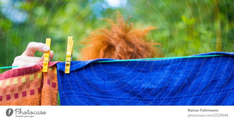 a woman hangs laundry on a clothesline outside Feminine Woman Adults Hair and hairstyles Hand 1 Human being Red-haired Work and employment Clean Determination
