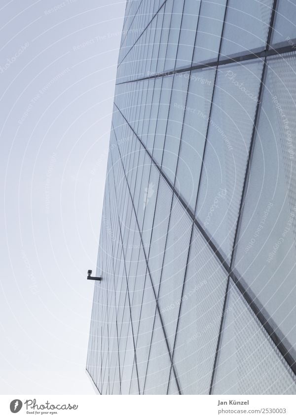 Modern glass facade architecture with surveillance camera Video camera Surveillance camera Surveillance device High-tech Sky Cloudless sky Town Deserted