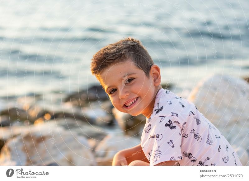 Portrait of a little boy on a breakwater Lifestyle Joy Happy Beautiful Vacation & Travel Summer Ocean Child Toddler Boy (child) Sky Coast Fashion Shirt
