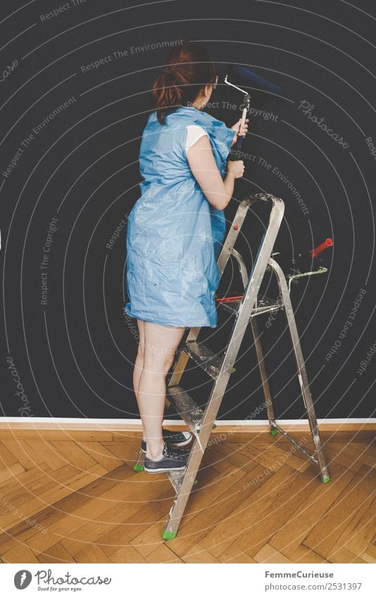 Woman in protective clothes coloring a wall with a paint roller Leisure and hobbies Feminine Adults 1 Human being Creativity Ladder painter's ladder