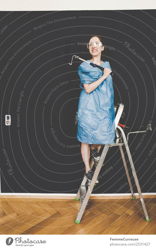Woman in protective clothes posing with a blue paint roller #DIY Leisure and hobbies Feminine Adults 1 Human being 18 - 30 years Youth (Young adults)
