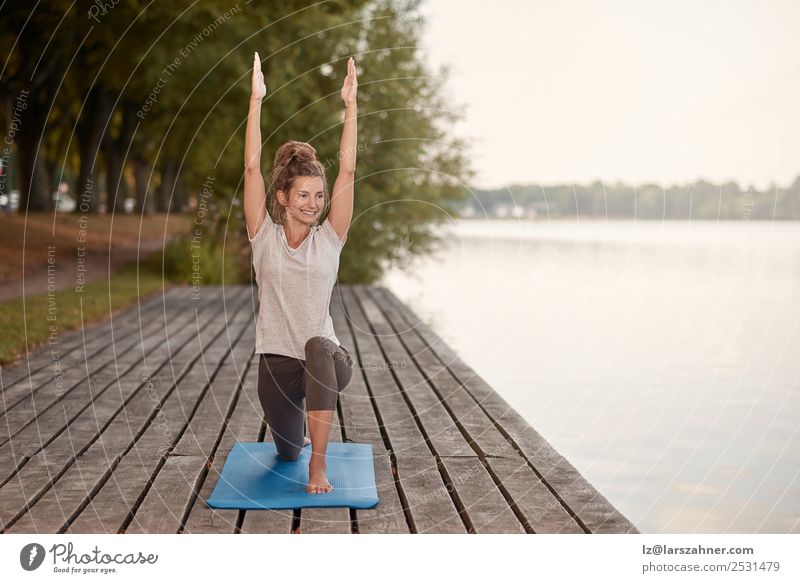 Happy young woman doing yoga on the lake Lifestyle pretty Body Wellness Relaxation Meditation Yoga Woman Adults 1 Human being 18 - 30 years Youth (Young adults)