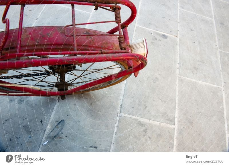 naked bike Playing Transport Means of transport Bicycle Stone Metal Driving Red Break Colour photo Exterior shot Deserted Copy Space right Copy Space bottom Day