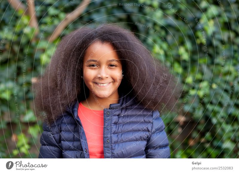 Pretty girl with long afro hair Happy Beautiful Face Winter Garden Child Human being Woman Adults Infancy Park Coat Brunette Afro Smiling Happiness Long Cute