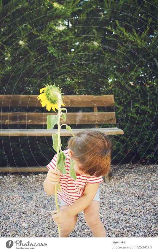 Little girl hold a sunflower Lifestyle Wellness Harmonious Leisure and hobbies Human being Feminine Child Toddler Girl Infancy 1 1 - 3 years Environment Nature