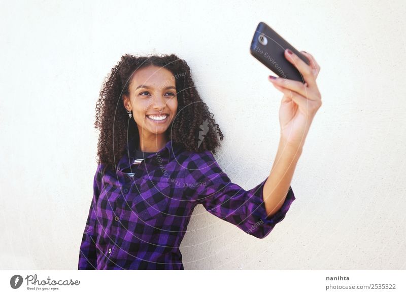 Young and happy woman taking a selfie Lifestyle Style Joy Hair and hairstyles Cellphone Camera PDA Technology Entertainment electronics Internet Human being