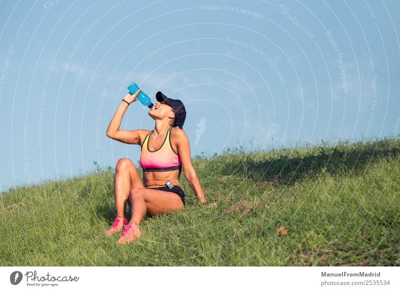athletic woman resting and drinking Drinking Bottle Lifestyle Beautiful Summer Sports Woman Adults Nature Park Fitness Sit Energy workout Runner training