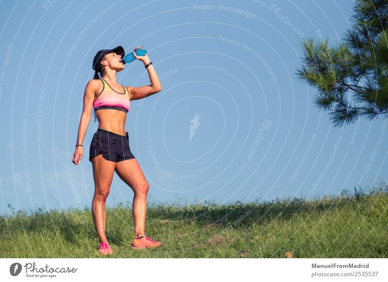 athletic woman resting and drinking Drinking Bottle Lifestyle Beautiful Summer Sports Woman Adults Nature Park Fitness Sit Energy workout Runner training