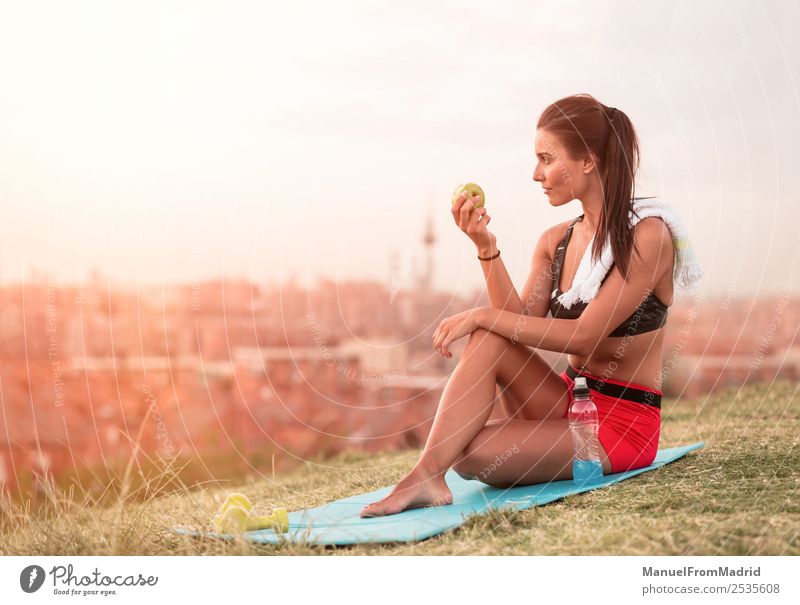 athletic woman eating an apple Fruit Apple Eating Lifestyle Beautiful Body Wellness Summer Sports Jogging Human being Woman Adults Nature Park Fitness Sit Green