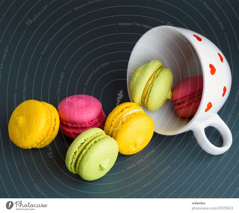 macarons in a white ceramic cup Dessert Mug Bright Yellow Pink Red Black White Colour Macaron background food colorful Vanilla french cake Vantage point Top