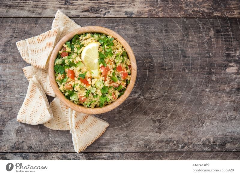 Tabbouleh salad with couscous on a wood Table Salad Vegetable Tomato Cucumber Parsley Mint Vegan diet Vegetarian diet Healthy Healthy Eating Nutrition Diet Bowl