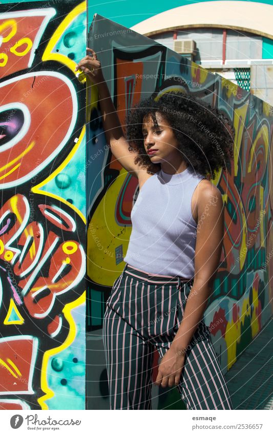 Urban woman with graffiti Lifestyle Exotic Joy Wellness Young woman Youth (Young adults) Art Culture Youth culture Town Wall (barrier) Wall (building) Fashion