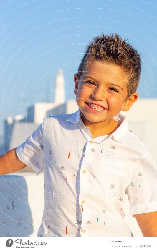 Cute boy with a white shirt in a blue sky background Lifestyle Style Joy Happy Beautiful Face Vacation & Travel Tourism Summer Success Child Human being