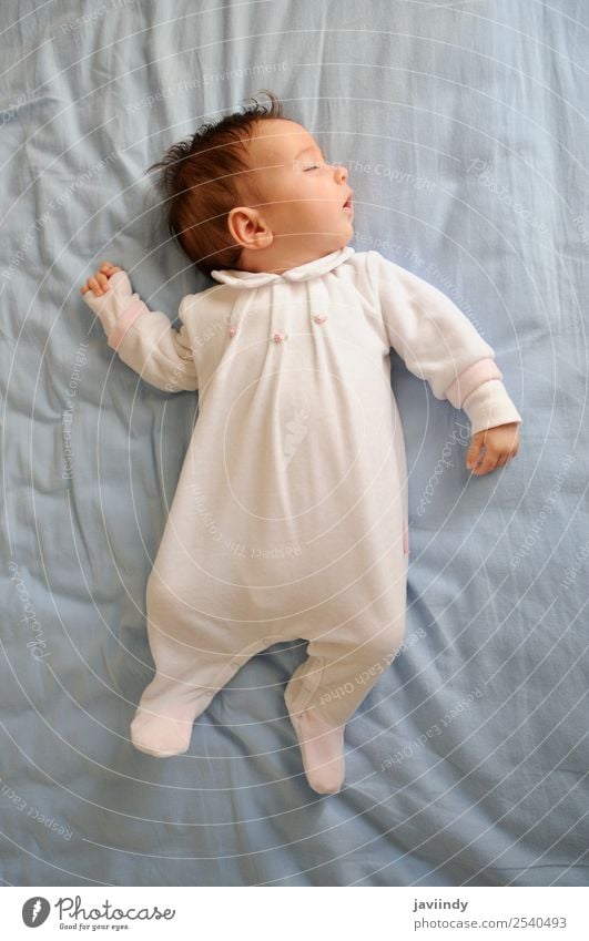 Newborn baby girl sleeping on blue sheets at home Happy Beautiful Face Life Child Human being Baby Girl Boy (child) Woman Adults Parents Infancy 1 0 - 12 months