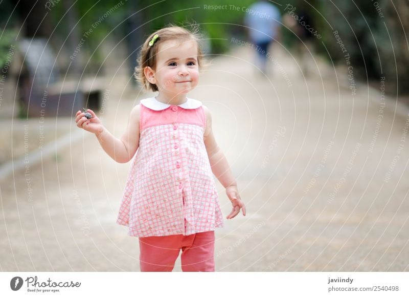 Little girl playing in a urban park Lifestyle Joy Happy Beautiful Leisure and hobbies Playing Summer Child Human being Girl Woman Adults Infancy 1 1 - 3 years