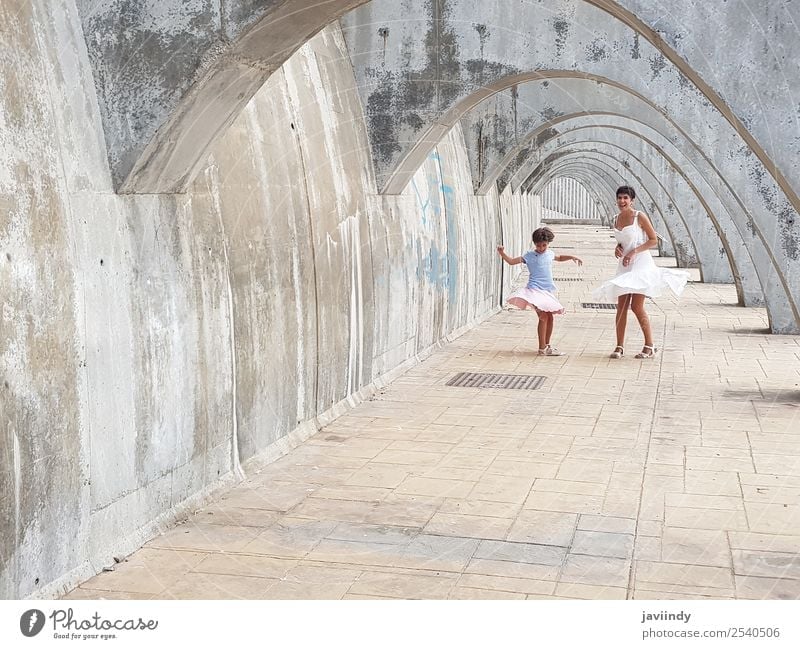 Funny mother and daughter dancing under arches Lifestyle Style Joy Happy Beautiful Playing Summer Dance Child Human being Feminine Woman Adults Parents Mother