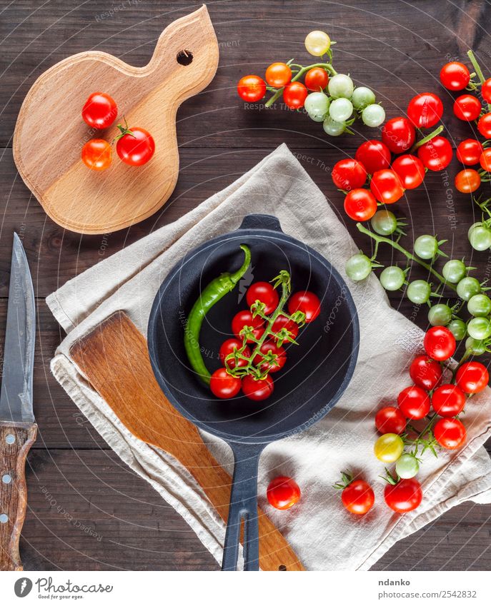 pan and ripe red cherry tomatoes Vegetable Vegetarian diet Pan Knives Kitchen Wood Fresh Small Natural Above Green Red Black Cherry Tomato food healthy