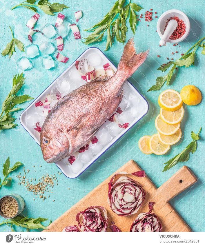 Dorado fish on kitchen table with ingredients Food Fish Herbs and spices Cooking oil Nutrition Lunch Dinner Organic produce Vegetarian diet Diet Crockery Style