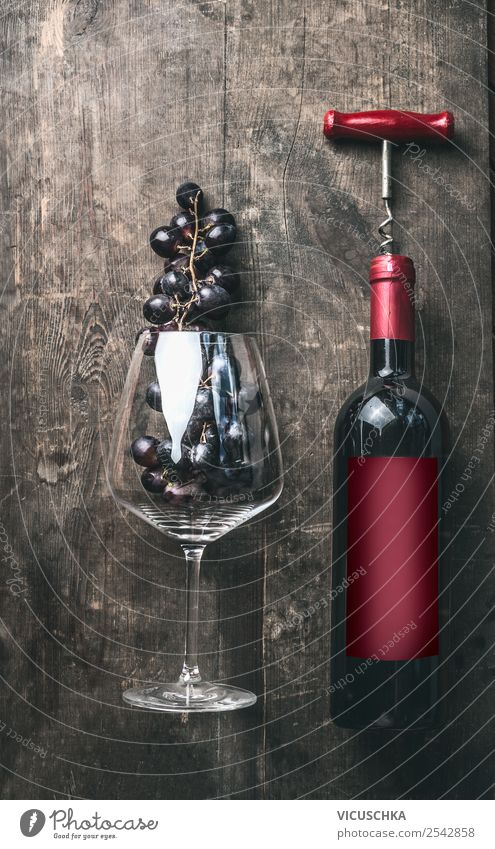 Red wine bottle and red wine glass with grapes Fruit Nutrition Dinner Banquet Beverage Alcoholic drinks Wine Bottle Glass Shopping Elegant Style Table